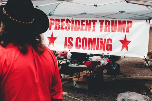 Trump nieuws op scherm met wereldkaart en financiële cijfers, relevant voor lezers in Leiden